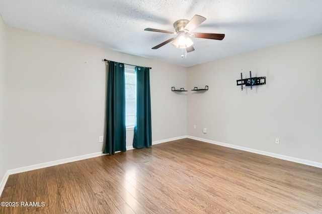 307 Creswell Ave, Scott, LA 70583 - spare room featuring a ceiling fan, baseboards, wood finished floors, and a textured ceiling