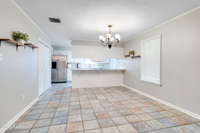 307 Creswell Ave, Scott, LA 70583 - kitchen with visible vents, open shelves, crown molding, a peninsula, and stainless steel fridge