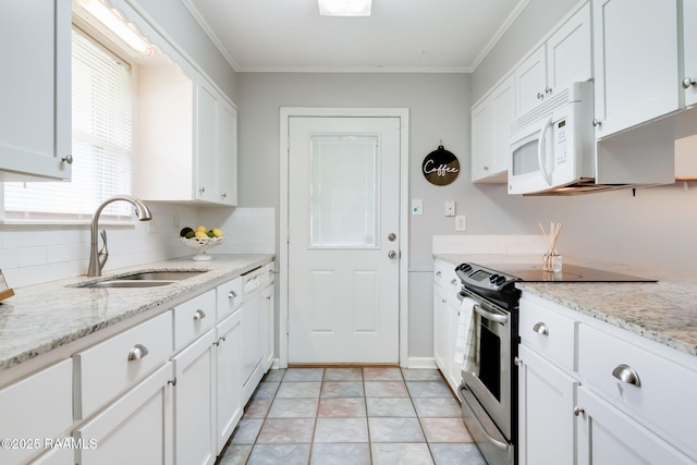 307 Creswell Ave, Scott, LA 70583 - kitchen featuring a sink, white cabinets, white microwave, and electric range