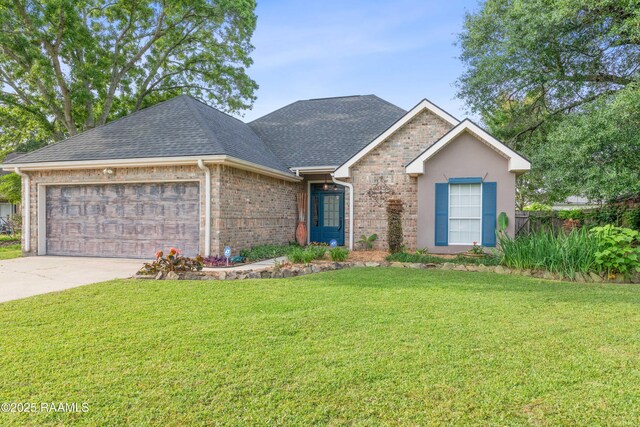 122 Ashford Ln, Youngsville, LA 70592 - view of front of property with a shingled roof, an attached garage, brick siding, a front yard, and driveway
