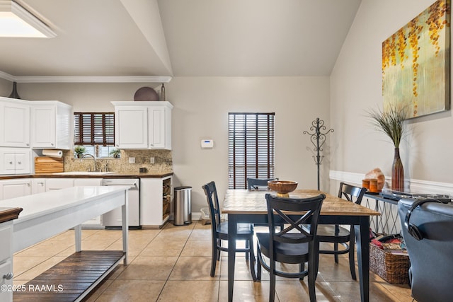 122 Ashford Ln, Youngsville, LA 70592 - dining space featuring light tile patterned floors, lofted ceiling, and ornamental molding