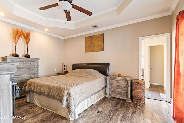 122 Ashford Ln, Youngsville, LA 70592 - bedroom featuring a tray ceiling, dark wood-type flooring, ornamental molding, recessed lighting, and a ceiling fan