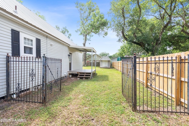 view of yard with a storage shed, an outdoor structure, and a fenced backyard