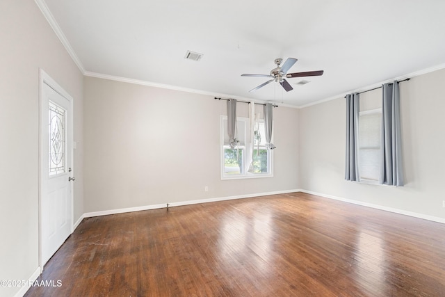 spare room featuring visible vents, ornamental molding, wood finished floors, baseboards, and a ceiling fan