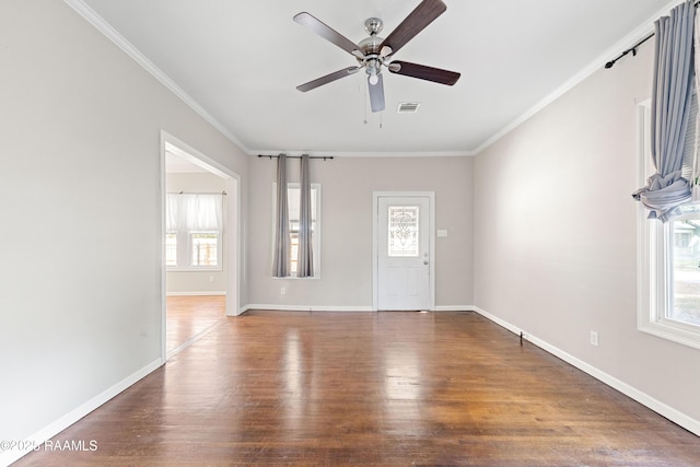 foyer entrance with visible vents, plenty of natural light, and wood finished floors