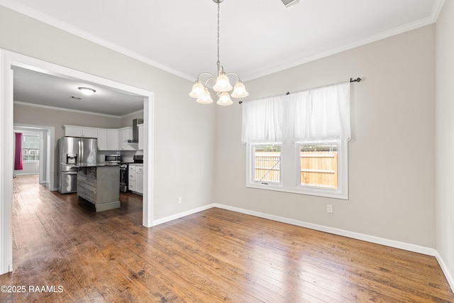 interior space with an inviting chandelier, baseboards, ornamental molding, and dark wood-style floors