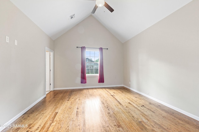 unfurnished room with visible vents, wood finished floors, baseboards, ceiling fan, and vaulted ceiling