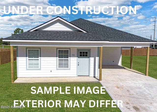 view of front of house with fence, a front yard, driveway, and roof with shingles