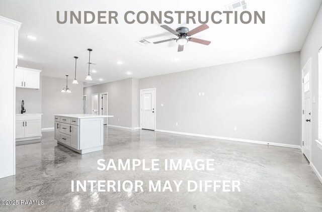 kitchen with baseboards, a ceiling fan, and visible vents