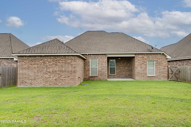 115 Maddox Jude Dr, Maurice, LA 70555 - back of property with a lawn, a fenced backyard, roof with shingles, and a patio area