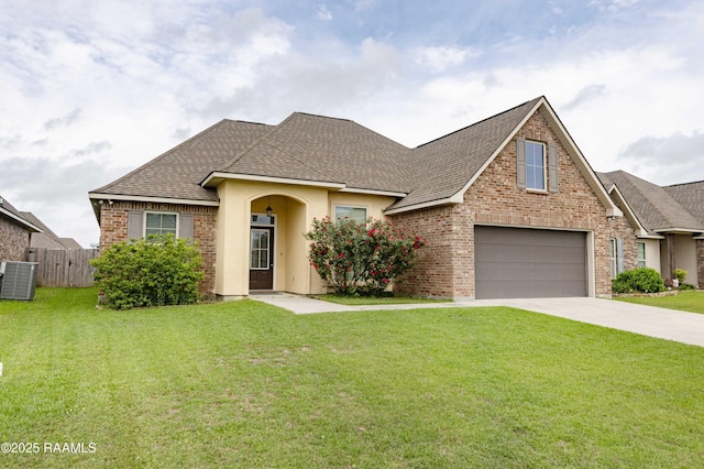 115 Maddox Jude Dr, Maurice, LA 70555 - view of front of home featuring central AC, fence, a front yard, roof with shingles, and concrete driveway