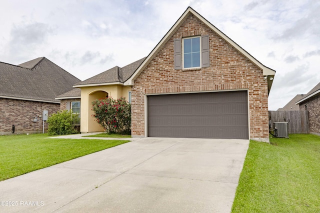 115 Maddox Jude Dr, Maurice, LA 70555 - traditional-style house featuring a garage, fence, a front yard, and concrete driveway
