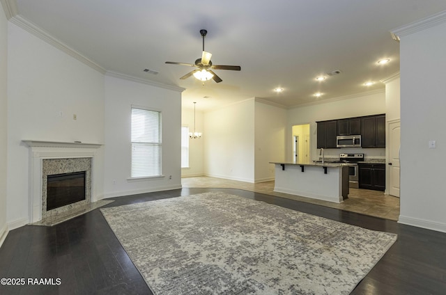 115 Maddox Jude Dr, Maurice, LA 70555 - unfurnished living room featuring visible vents, ornamental molding, a high end fireplace, dark wood finished floors, and ceiling fan with notable chandelier