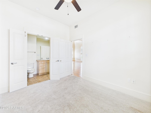 1127 Camellia Blvd Unit H1, Lafayette, LA 70508 - unfurnished bedroom featuring light colored carpet, ensuite bath, baseboards, and ceiling fan