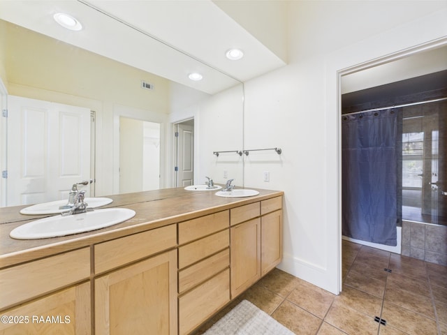 1127 Camellia Blvd Unit H1, Lafayette, LA 70508 - full bathroom featuring tile patterned flooring, a tile shower, double vanity, recessed lighting, and baseboards
