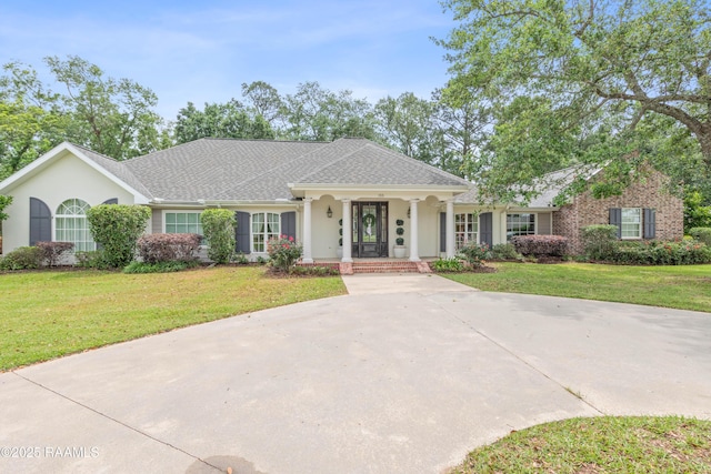 ranch-style house with covered porch, stucco siding, and a front lawn