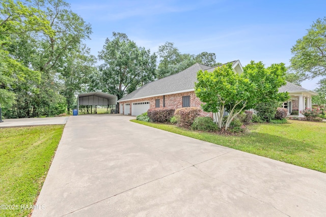 view of front of property with a garage, a detached carport, a front yard, brick siding, and concrete driveway