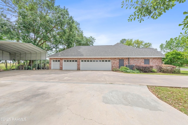 view of front of property featuring concrete driveway, brick siding, a garage, and central air condition unit