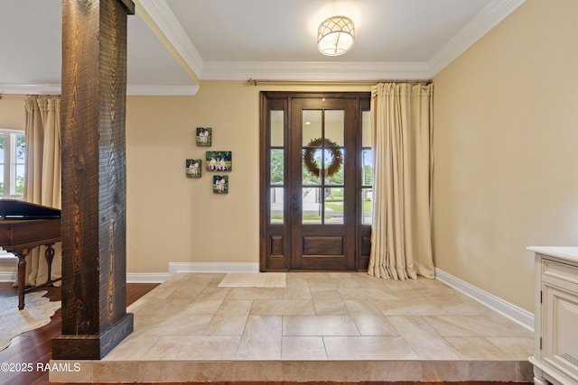 entrance foyer with baseboards and crown molding