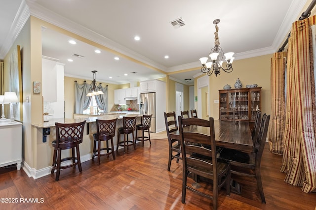 dining area featuring a chandelier, ornamental molding, visible vents, and dark wood-type flooring