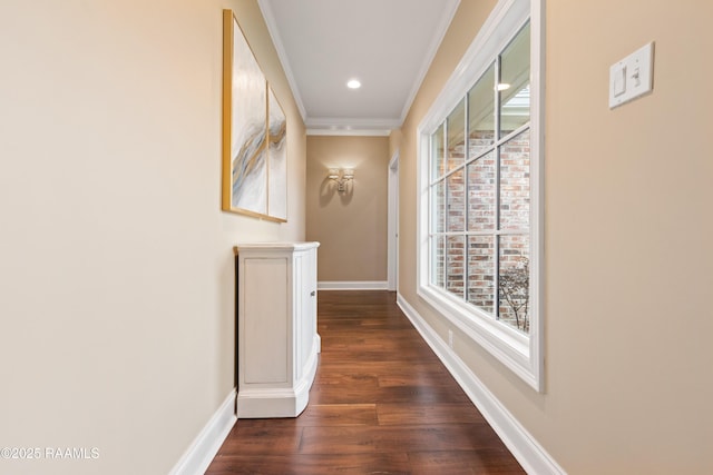 hallway featuring baseboards, recessed lighting, crown molding, and wood finished floors