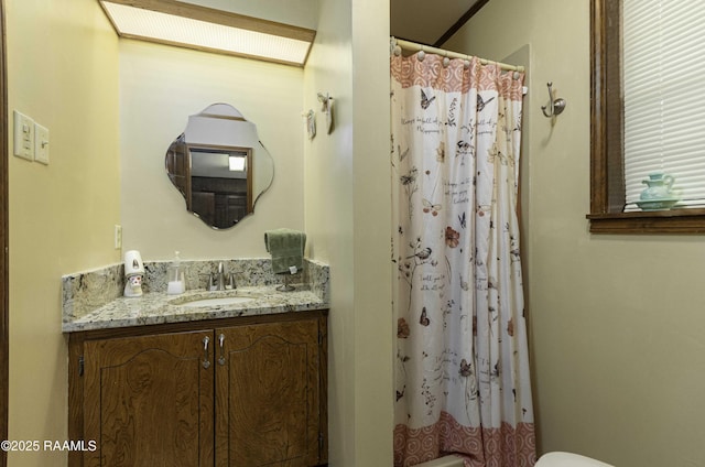 bathroom featuring a shower with curtain and vanity