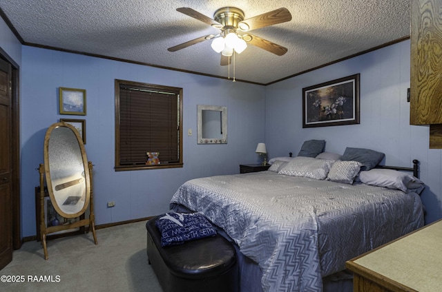 carpeted bedroom featuring a ceiling fan, ornamental molding, a textured ceiling, and baseboards