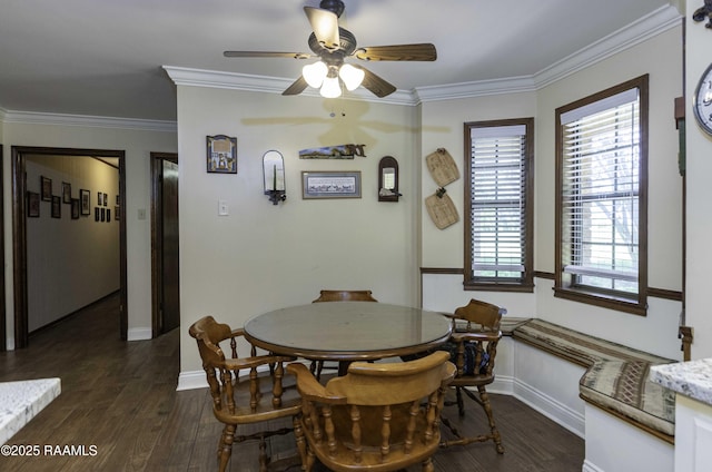 dining area with crown molding, plenty of natural light, dark wood-type flooring, and a ceiling fan