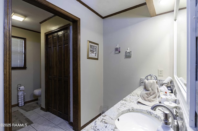 full bath featuring toilet, ornamental molding, a sink, tile patterned floors, and double vanity