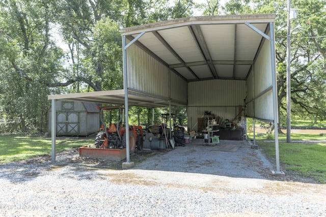 view of parking / parking lot featuring a detached carport and a storage unit