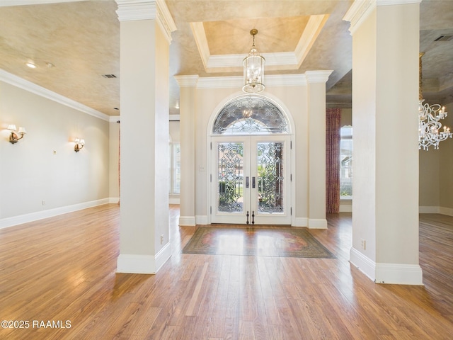 107 Wembley Rd, Lafayette, LA 70503 - foyer entrance with a notable chandelier, french doors, baseboards, wood finished floors, and ornamental molding