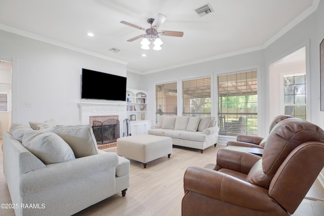 502 River Woods Dr, Lafayette, LA 70508 - living room with ornamental molding, ceiling fan, a fireplace, light wood finished floors, and recessed lighting