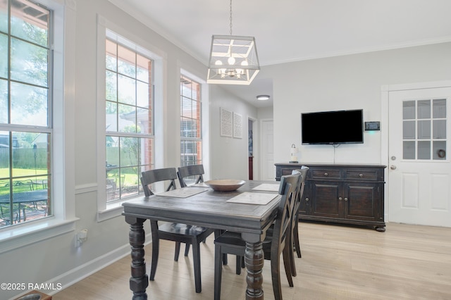 502 River Woods Dr, Lafayette, LA 70508 - dining space featuring a chandelier, ornamental molding, light wood-style floors, and baseboards