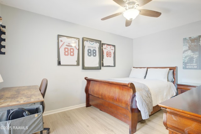 502 River Woods Dr, Lafayette, LA 70508 - bedroom featuring light wood finished floors, a ceiling fan, and baseboards