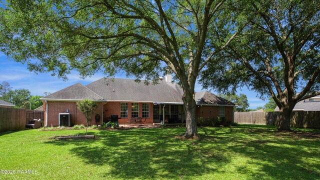 502 River Woods Dr, Lafayette, LA 70508 - rear view of property with brick siding, central AC, and a patio area