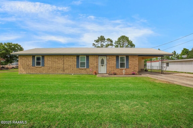 ranch-style house with driveway, an attached carport, a front yard, and metal roof