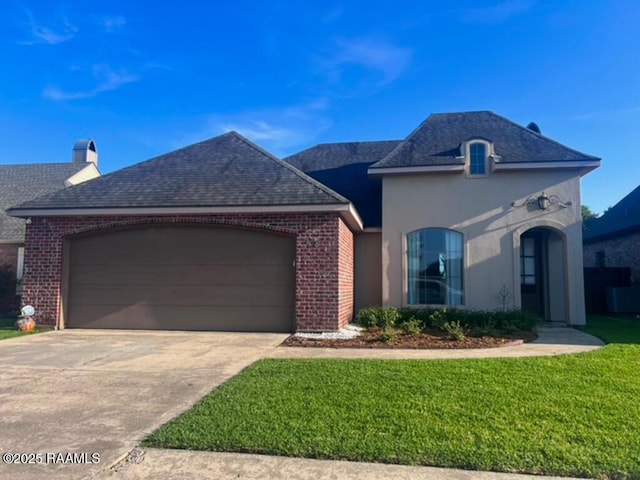 204 Red Cedar Ln, Youngsville, LA 70592 - view of front of house featuring a shingled roof, an attached garage, brick siding, a front yard, and driveway