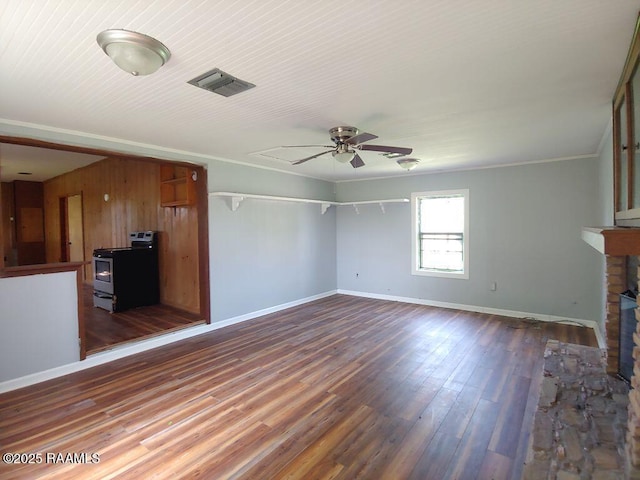 unfurnished living room with ceiling fan, visible vents, crown molding, baseboards, and dark wood-type flooring
