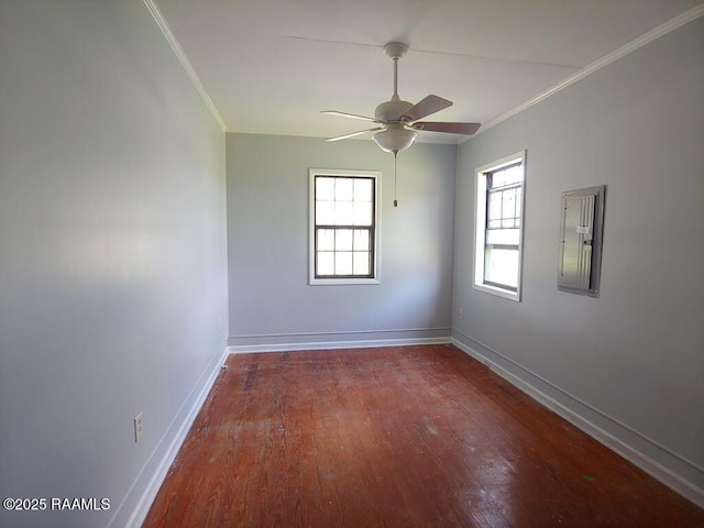 empty room with a ceiling fan, baseboards, ornamental molding, and wood finished floors