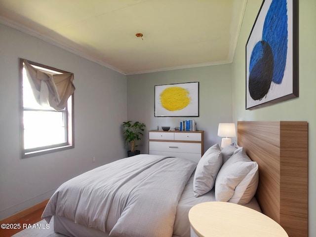 bedroom with crown molding and baseboards