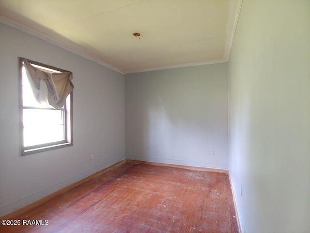 unfurnished room with crown molding, baseboards, and hardwood / wood-style flooring