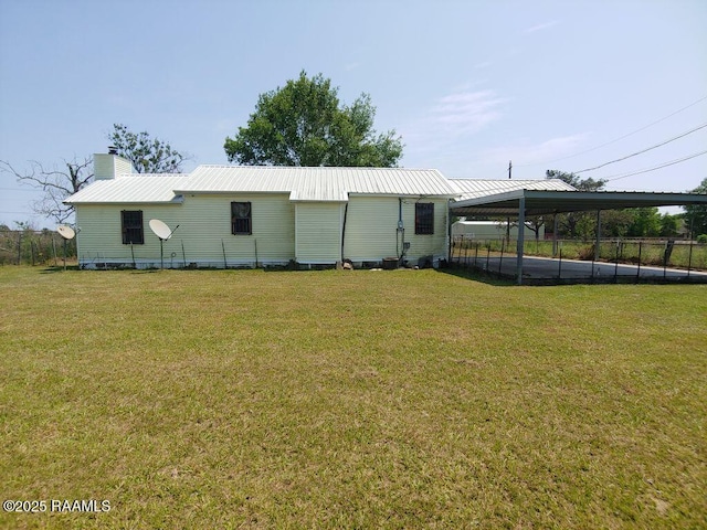 view of outbuilding featuring a detached carport and fence
