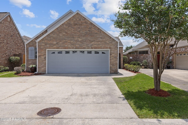 view of front of property featuring a garage, driveway, and brick siding