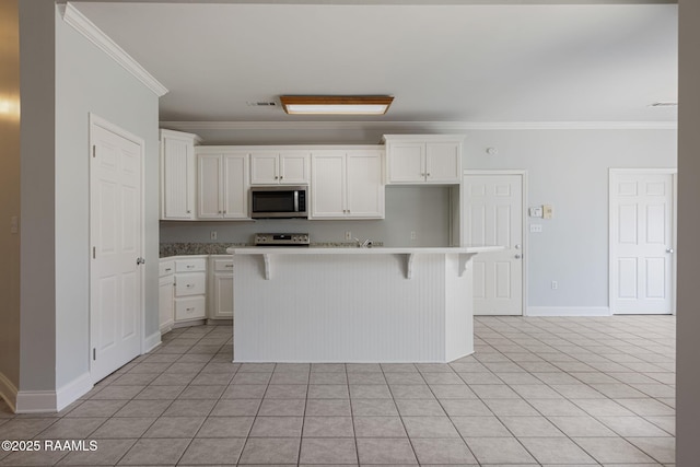 kitchen with crown molding, stainless steel appliances, white cabinets, and visible vents