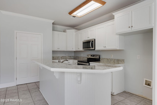 kitchen featuring light countertops, white cabinets, light tile patterned flooring, and stainless steel appliances
