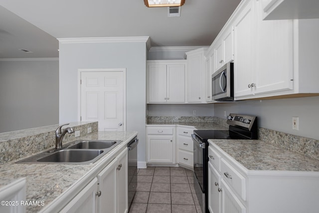 kitchen with light countertops, a sink, white cabinets, and stainless steel appliances