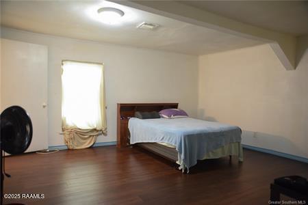 bedroom with wood finished floors