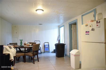 dining space featuring light tile patterned floors