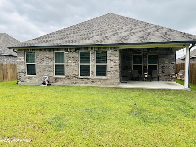 131 Wild Cherry Ln, Lafayette, LA 70508 - back of property featuring roof with shingles, a patio, and brick siding