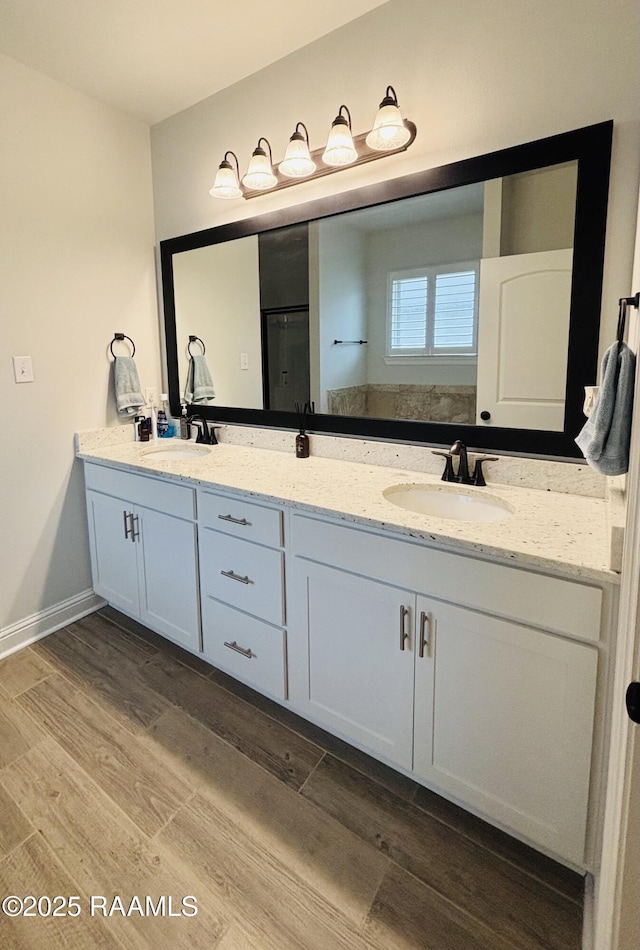 131 Wild Cherry Ln, Lafayette, LA 70508 - bathroom with wood finished floors, double vanity, and a shower with shower door